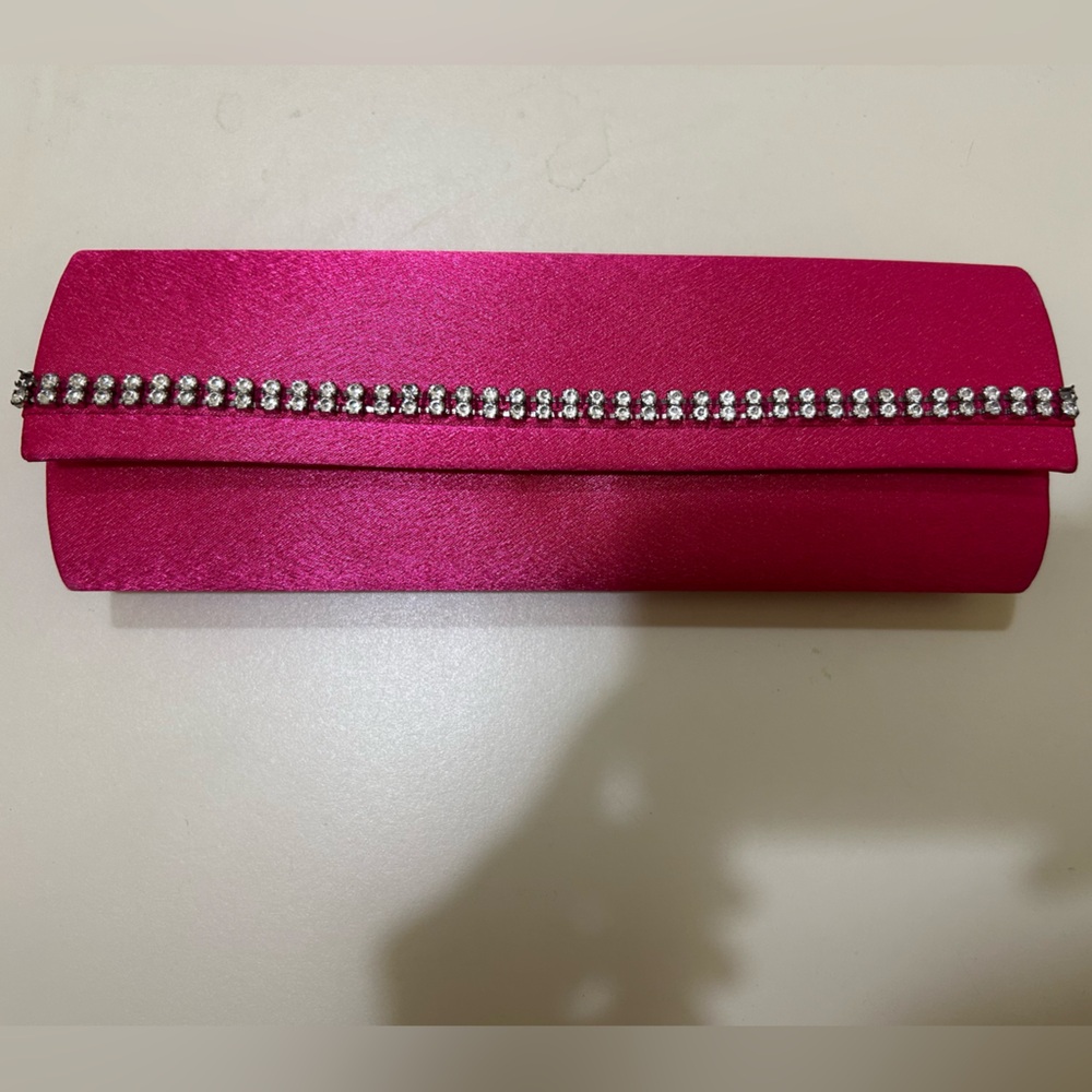Cache clutch, hot pink. Missing rhinestones - 1 each on each end of top row